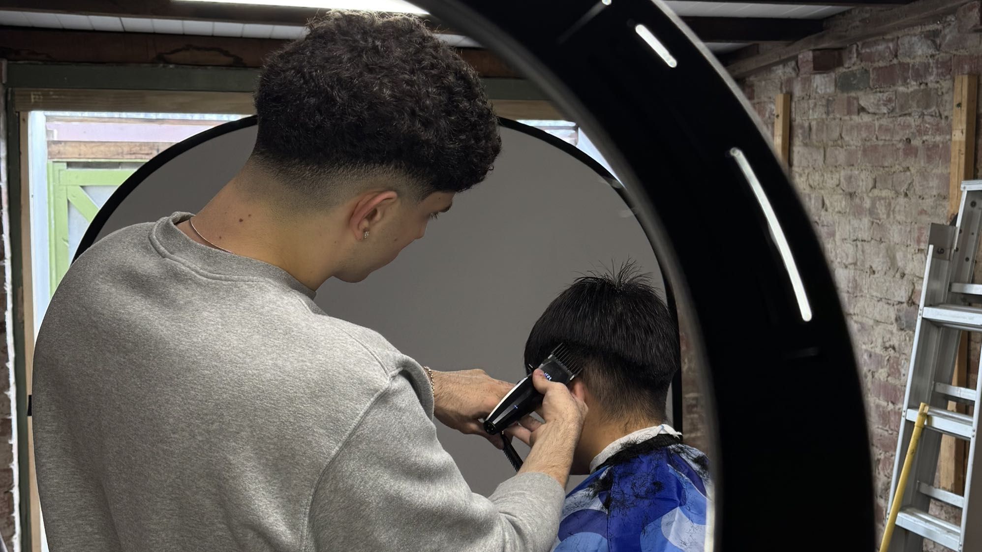 Vance cutting a client’s hair